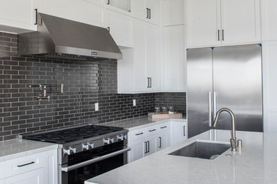 Trendy l-shaped light wood floor and gray floor eat-in kitchen photo with shaker cabinets, white cabinets and an island