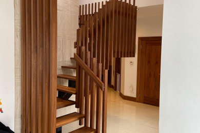 Existing steel spine stairs transformed into Solid Iroko balustrades