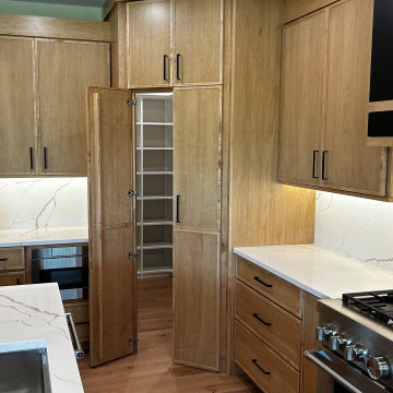 Maple Pecan Stain and Painted Black Kitchen Design in Bettendorf, Iowa