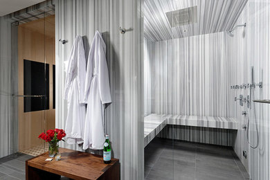 Small trendy slate floor wet room photo in Denver with furniture-like cabinets, white cabinets, a wall-mount toilet, white walls, an integrated sink and marble countertops