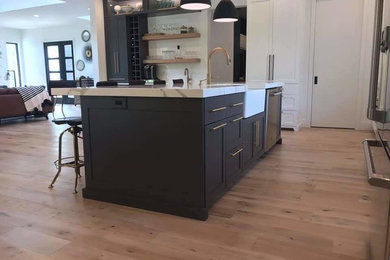 Example of a kitchen design in Chicago with shaker cabinets, gray cabinets, quartzite countertops and an island