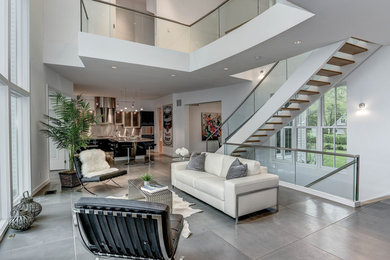 Living room - large contemporary open concept and formal concrete floor and gray floor living room idea in DC Metro with white walls, a standard fireplace, a tile fireplace and no tv
