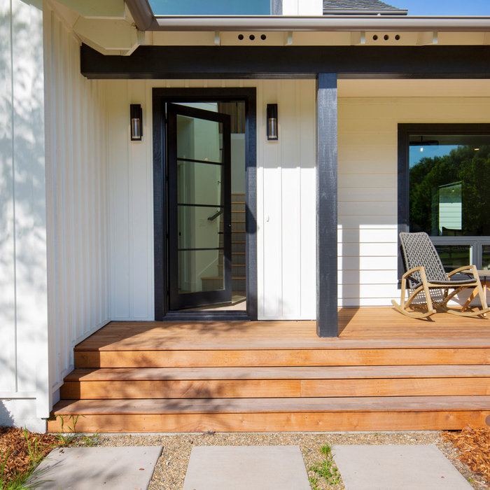 Country white board and batten exterior home photo in San Francisco