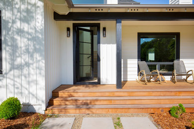 Country white board and batten exterior home photo in San Francisco