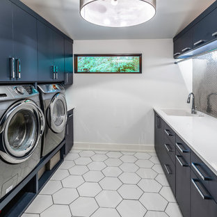 Photo of a contemporary galley utility room in Nashville with a submerged sink, flat-panel cabinets, blue cabinets, white walls, white floors and white worktops.