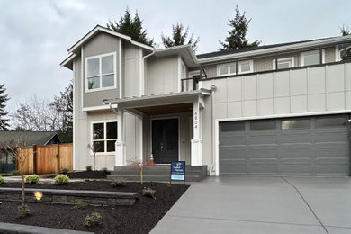 Inspiration for a large contemporary two-story mixed siding exterior home remodel in Seattle with a shingle roof
