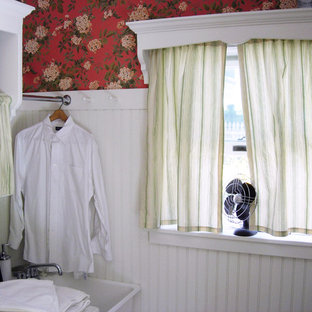 Small traditional l-shaped utility room in New York with an utility sink, open cabinets, white cabinets, wood worktops, multi-coloured walls, terracotta flooring, a side by side washer and dryer and orange floors.