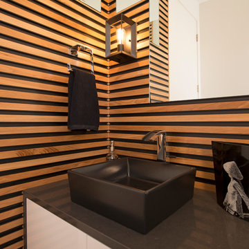 Unique wood slat wall add character to this powder room.