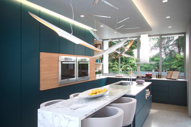 Mid-sized trendy l-shaped light wood floor enclosed kitchen photo in Miami with an undermount sink, flat-panel cabinets, blue cabinets, marble countertops, stainless steel appliances and an island