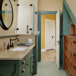 Corner shower - transitional white tile and subway tile mosaic tile floor and green floor corner shower idea in Houston with shaker cabinets, green cabinets, beige walls, an undermount sink, a hinged shower door and beige countertops