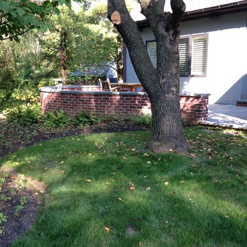 perfect fit: brick walls, bluestone patio, lighting & plantings