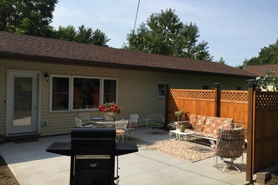 Mid-sized elegant backyard concrete patio photo in Minneapolis with no cover