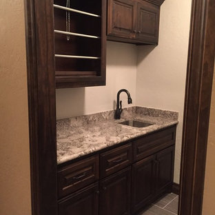 Medium sized scandinavian separated utility room in Oklahoma City with a submerged sink, dark wood cabinets, granite worktops, raised-panel cabinets, white walls and plywood flooring.