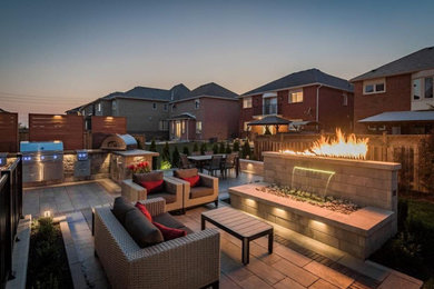 Example of a transitional patio design in Toronto