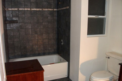 Inspiration for a mid-sized timeless master gray tile and porcelain tile slate floor and gray floor bathroom remodel in San Diego with recessed-panel cabinets, medium tone wood cabinets, gray walls and wood countertops