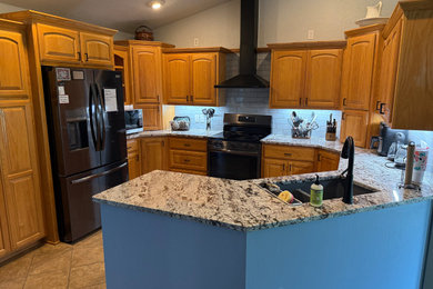 Example of a mid-sized country u-shaped kitchen design in Other with an undermount sink, orange cabinets and ceramic backsplash