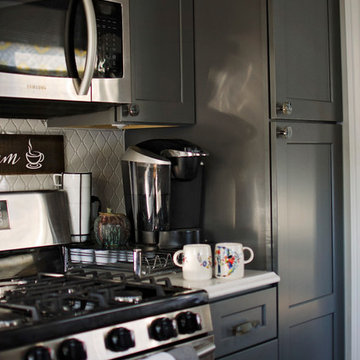Timberwood glass knobs freshen this grey kitchen.