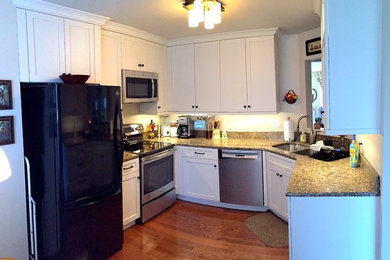 Inspiration for a small timeless u-shaped medium tone wood floor eat-in kitchen remodel in Baltimore with an undermount sink, shaker cabinets, white cabinets, granite countertops, stainless steel appliances and no island