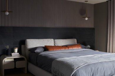 Trendy master light wood floor and wall paneling bedroom photo in Toronto with black walls