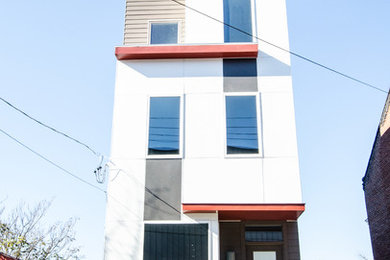 Modern white three-story concrete fiberboard exterior home idea in Other
