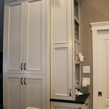 Storage closet with bill holder corkboard and key holder inside small doors