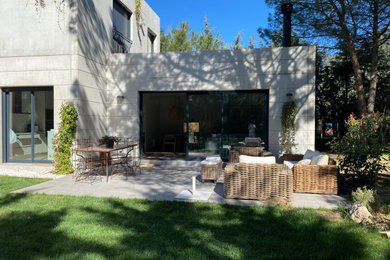 Modelo de fachada de casa gris moderna de tamaño medio de dos plantas con revestimiento de hormigón y tejado plano