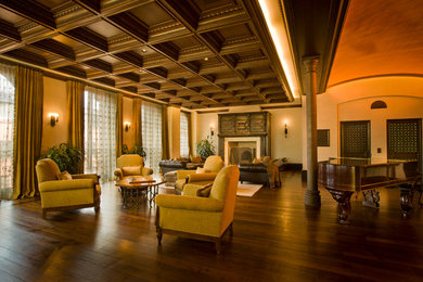 Inspiration for a large timeless formal and open concept dark wood floor and brown floor living room remodel in New York with beige walls, a standard fireplace and a plaster fireplace