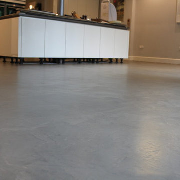 Polished concrete floor in bronze colour over existing floor tiles London