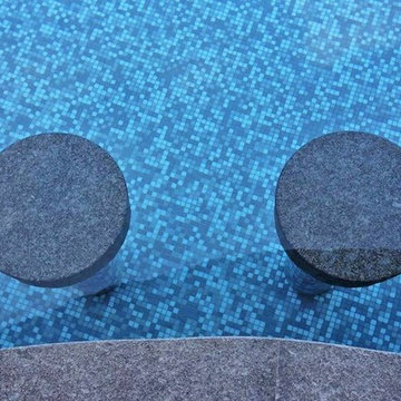 Contemporary pool with custom mosaic mix and pool seats