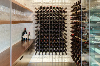 Small contemporary wine cellar in Los Angeles with slate floors, grey floor and storage racks.