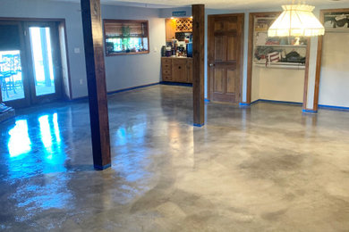 Large walk-out concrete floor and gray floor basement photo in Other