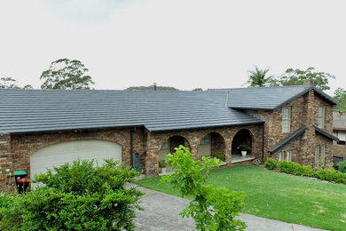 This is an example of a modern exterior in Sydney with a tile roof.
