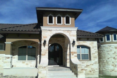 Example of a tuscan brown one-story stone exterior home design in Austin