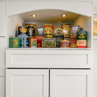 Photo of a large industrial l-shaped kitchen pantry in Calgary with shaker cabinets, white cabinets, dark hardwood floors, an undermount sink, marble benchtops, white splashback, brick splashback, stainless steel appliances and multiple islands.