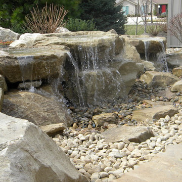 Carved stone water feature pondless and stone patio