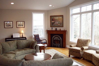 Inspiration for a mid-sized timeless formal light wood floor living room remodel in Dallas with beige walls, a corner fireplace and a wood fireplace surround
