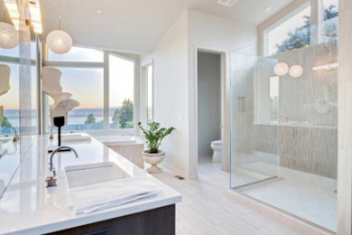 Example of a large classic master beige tile and porcelain tile porcelain tile bathroom design in Los Angeles with a drop-in sink, flat-panel cabinets, dark wood cabinets, quartz countertops, a one-piece toilet and white walls