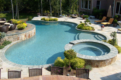 Inspiration for a large transitional backyard custom-shaped pool in Other with a hot tub and tile.