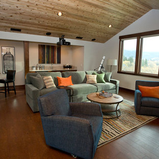 This is an example of a large traditional open plan home cinema in Portland with beige walls, cork flooring and a projector screen.