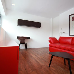 Example of a mid-sized trendy enclosed home theater design in Munich with white walls