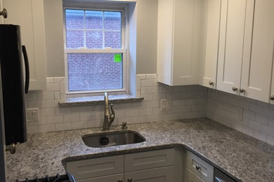 Inspiration for a small transitional u-shaped enclosed kitchen remodel in Philadelphia with an undermount sink, shaker cabinets, white cabinets, granite countertops, white backsplash, subway tile backsplash, stainless steel appliances and no island