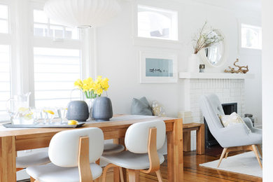 Small 1960s medium tone wood floor kitchen/dining room combo photo in Vancouver with white walls and no fireplace