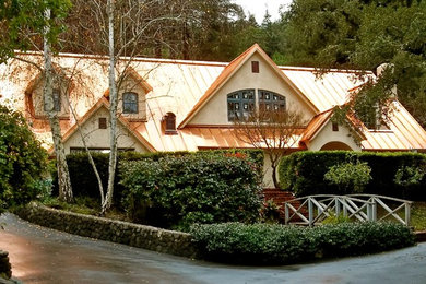 Example of a large trendy beige two-story stucco exterior home design in San Francisco with a mixed material roof