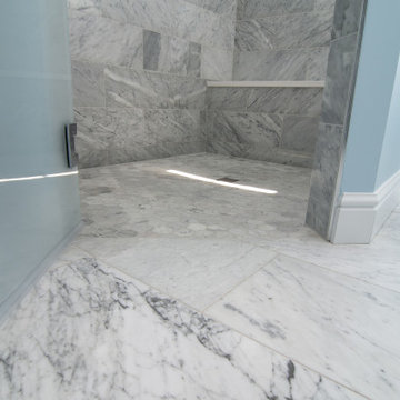 Traditional master bath utilizing frosted and clear glass to allow for needed pr