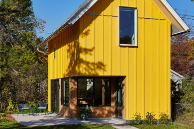 Design ideas for a yellow modern house exterior in Minneapolis.