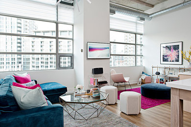 Inspiration for a modern loft-style living room in Toronto with white walls, laminate floors and a wall-mounted tv.