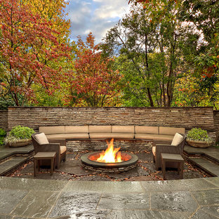 Transitional patio in Dallas with a fire feature and no cover.