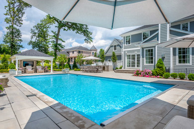 Pool - mid-sized traditional backyard concrete paver pool idea in New York
