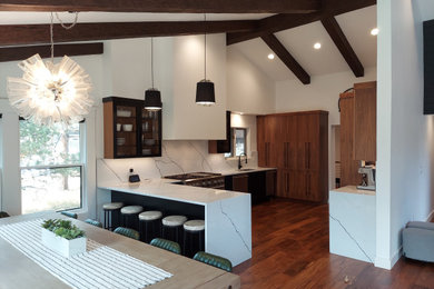 Inspiration for a mid-sized contemporary u-shaped medium tone wood floor eat-in kitchen remodel in Denver with a single-bowl sink, flat-panel cabinets, dark wood cabinets, quartz countertops, white backsplash, quartz backsplash, stainless steel appliances, a peninsula and white countertops