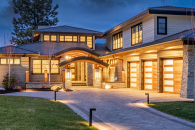 Large trendy gray two-story wood house exterior photo in Other with a hip roof and a tile roof